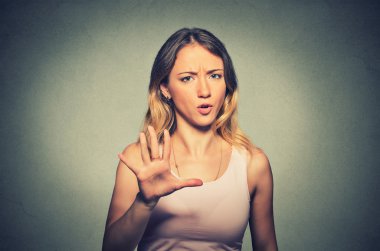 angry annoyed woman raising hand up to say no stop 