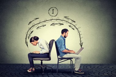 Man and woman working on laptops exchanging information 