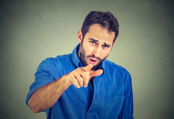 Portrait of a angry young man pointing finger at someone — Stock Photo, Image