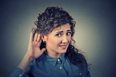 unhappy hard of hearing woman placing hand on ear asking someone to speak up clipart