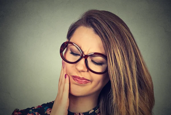 Woman in glasses with sensitive toothache crown problem about to cry from pain — Stock Photo, Image