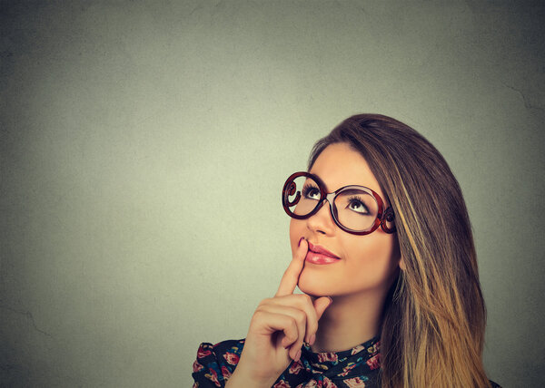happy beautiful woman thinking looking up