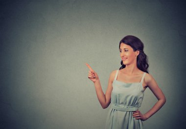 young woman showing pointing with finger at copy space for product or text