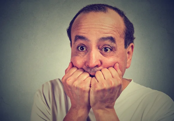 Scared middle aged guy biting his nails looking anxious in panic — Stock Photo, Image