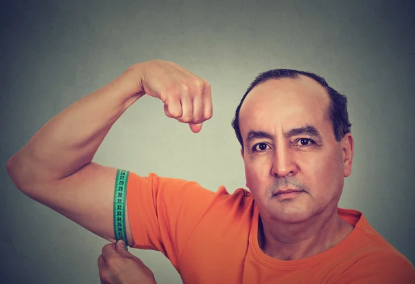 Hombre flexionando su músculo midiendo sus bíceps. Resultado del objetivo Fitness — Foto de Stock