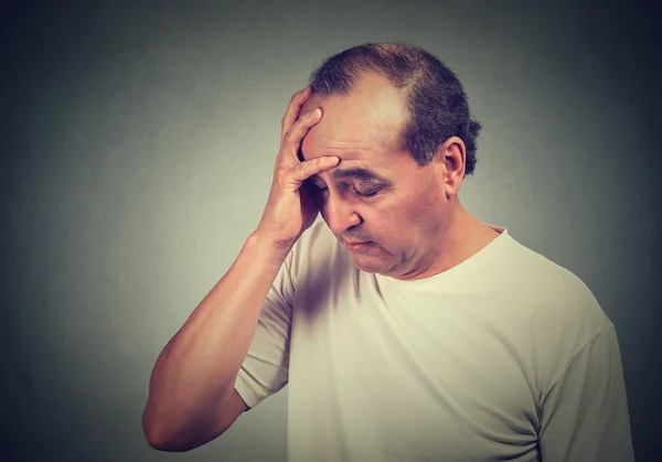 Portrait of middle aged desperate man isolated on gray wall background — Stock Photo, Image