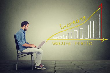 Young man using a laptop. IT guy young man working on notebook has a plan to increase website traffic.