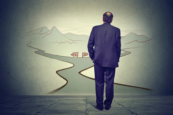 Business man in front of two roads thinking deciding hoping for best taking chance — Stock Photo, Image