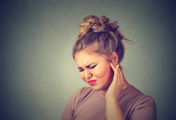 Tinnitus. Sick woman having ear pain touching her painful head — Stock Photo, Image