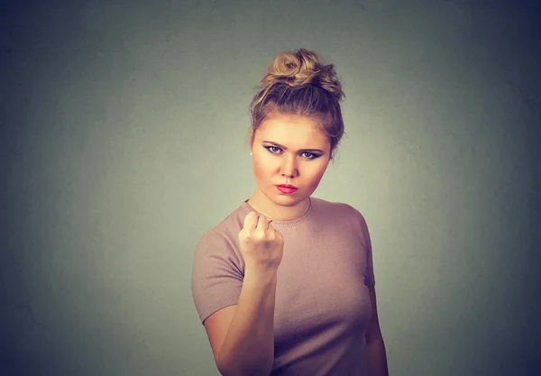 Angry young woman with fist up — Stock Photo, Image