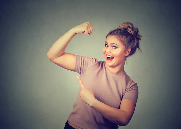 Young happy woman flexing muscles showing her strength. Weight loss concept — Stok fotoğraf