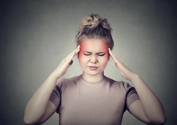 Woman with headache, migraine, stress, insomnia temples colored in red — Stock Photo, Image