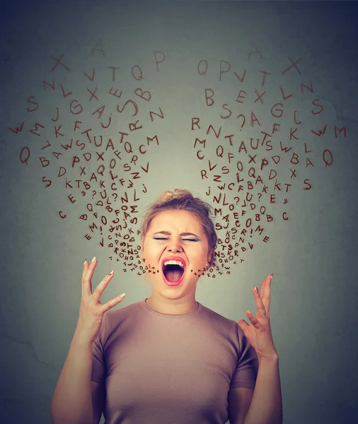Angry woman screaming, alphabet letters coming out of open mouth — Stock Photo, Image