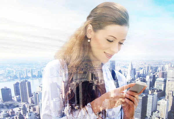 Business woman texting on smart phone isolated on double exposure cityscape background — Stock Photo, Image