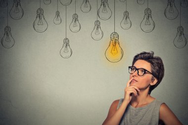 Portrait thinking woman in glasses looking up with light idea bulb above head clipart