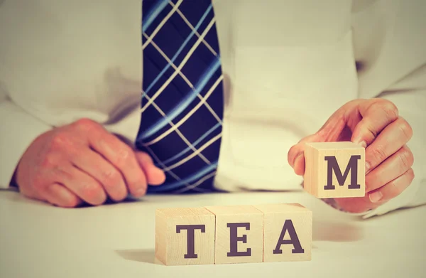 Business man arranging cubes reading Team on table. Power of cooperation partnership concept — Stock Photo, Image