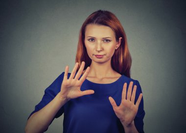 annoyed angry woman with bad attitude gesturing with palms outward to stop 