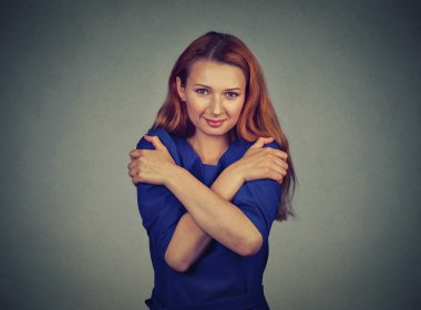 confident smiling woman holding hugging herself 