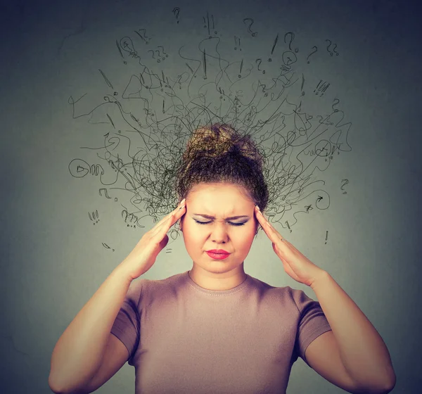 Woman with worried stressed face expression and brain melting into lines question marks. — Stok fotoğraf