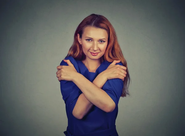 Confident smiling woman holding hugging herself — Stok fotoğraf