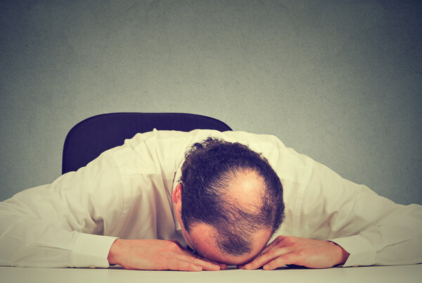 tired middle aged bald boss company employee sleeping after long working hours