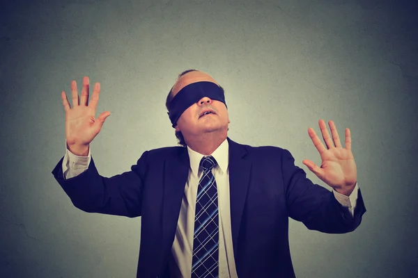 Business man in suit blindfolded stretching his arms out — Stock Photo, Image