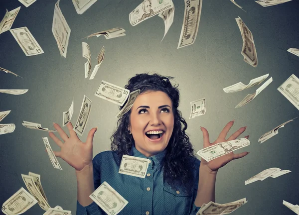 Woman exults pumping fists ecstatic celebrates success under money rain falling down dollar bills banknotes — Stock Photo, Image