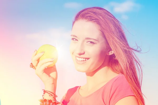 Szczęśliwa kobieta z apple, uśmiechając się, ciesząc się słoneczny dzień dobry pogoda nad morzem — Zdjęcie stockowe