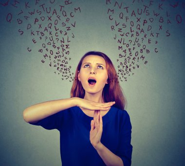 Woman showing time out gesture screaming to stop alphabet letters coming out of mouth