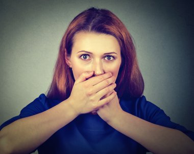 Concerned scared woman covering her mouth with hands  clipart