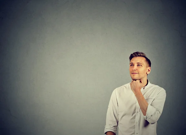 Happy young man thinking dreaming looking up — Stock Photo, Image