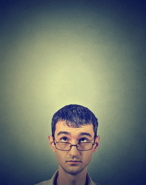 Closeup portrait pensive young man looking up — Stock Photo, Image