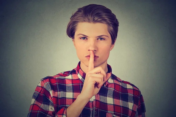 Young handsome man giving Shhhh quiet, silence gesture — Stock Photo, Image