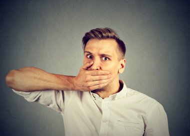 Korkmuş genç adam el ile ağız kapsayan 