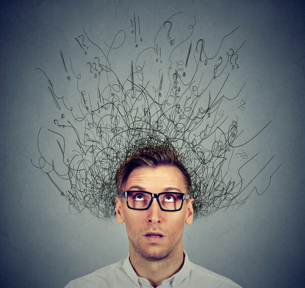 man with worried face expression brain melting into lines question marks 