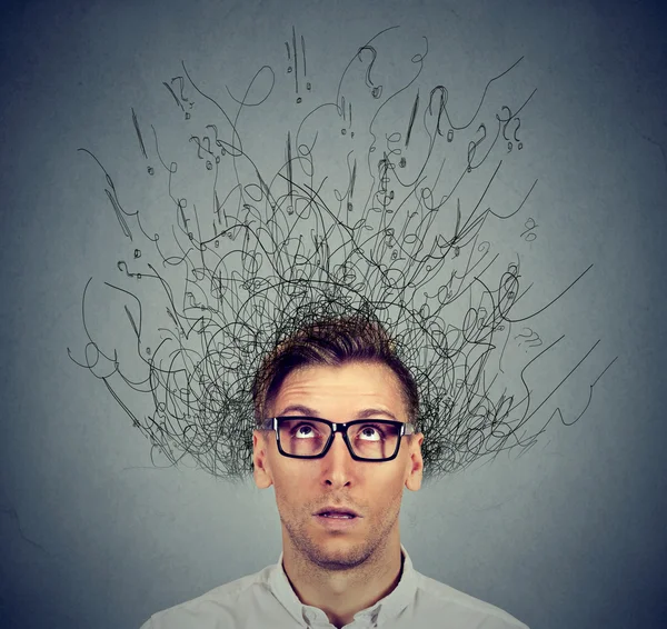 Man with worried face expression brain melting into lines question marks Stock Picture