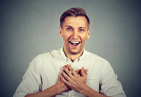 Hombre mirando sorprendido sorprendido riendo manos en el pecho — Foto de Stock