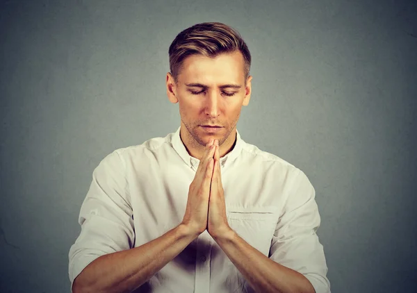 Young sad man praying — Stock Photo, Image