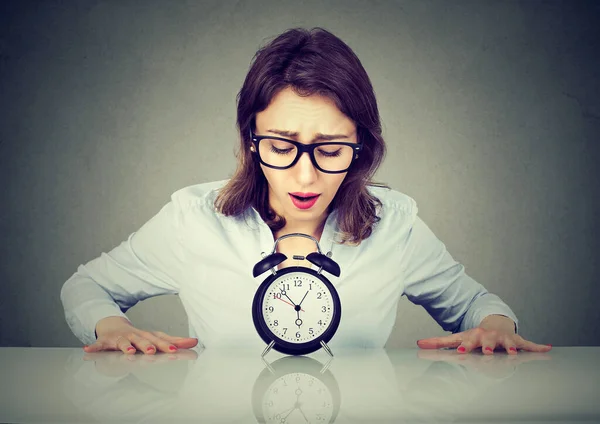 Anxious Young Woman Sitting Table Looking Alarm Clock — Stock Photo, Image