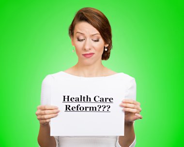 Skeptical woman holding sign health care reform?  clipart