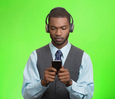 businessman with headphones browsing internet on smart phone