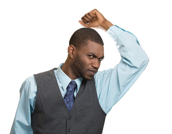 Man, smelling sniffing his armpit, something stinks bad