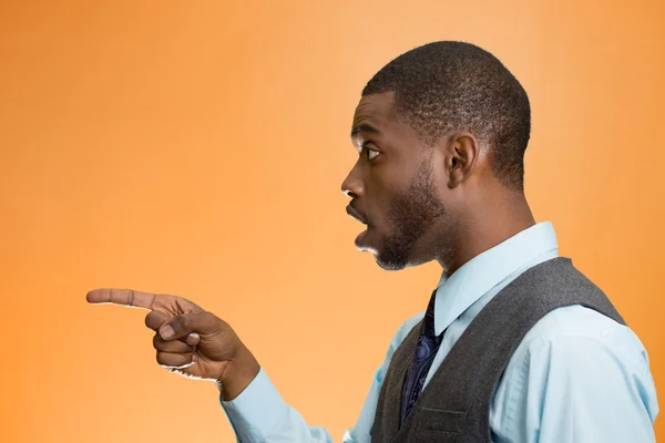 Man pointing with index finger at something, stunned — Stock Photo, Image