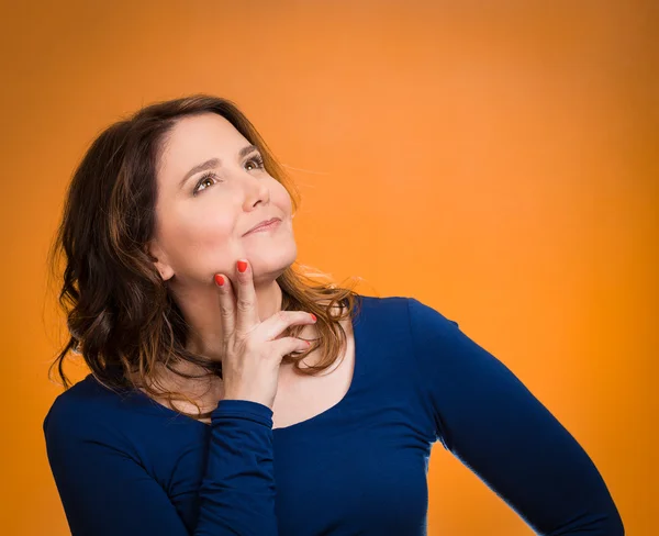 Happy, middle aged woman looking upwards daydreaming — Stock Photo, Image