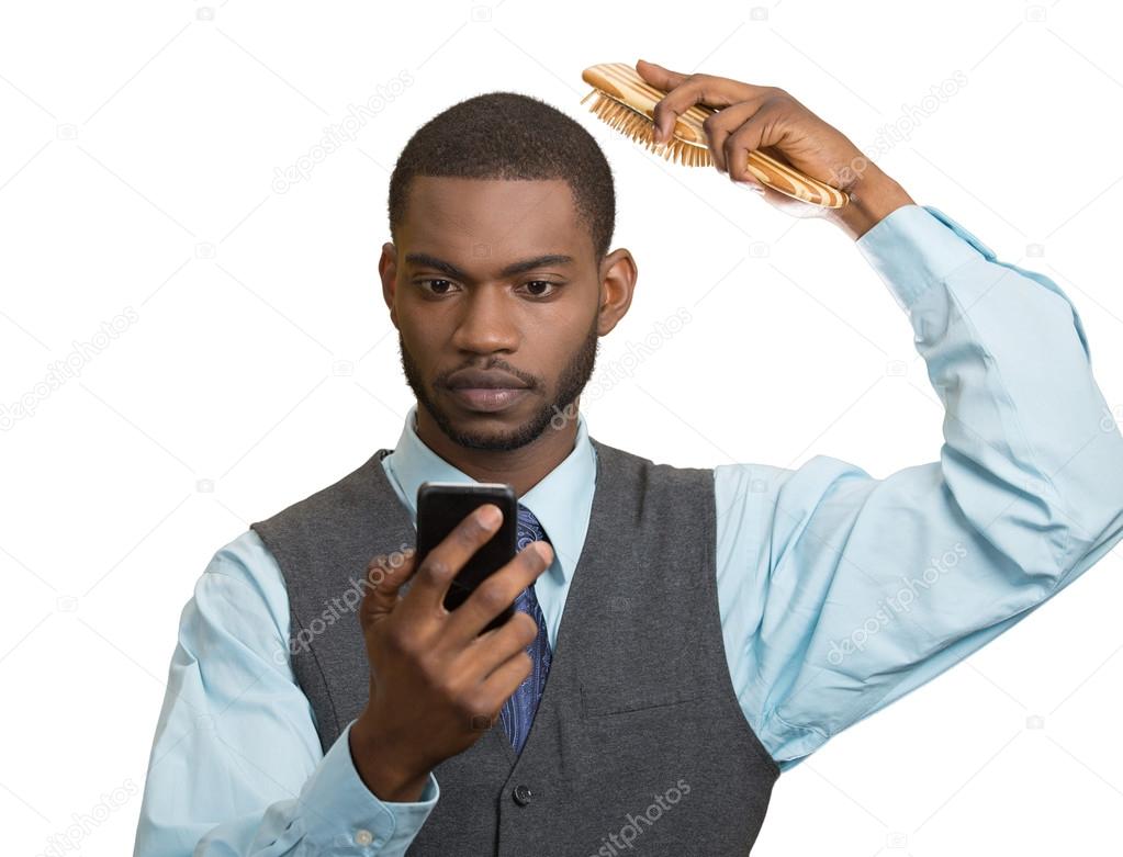 Business man, reading news on smart phone, combing  hair 