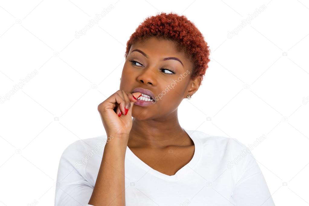 Woman with finger in mouth, sucking thumb, biting fingernail in stress
