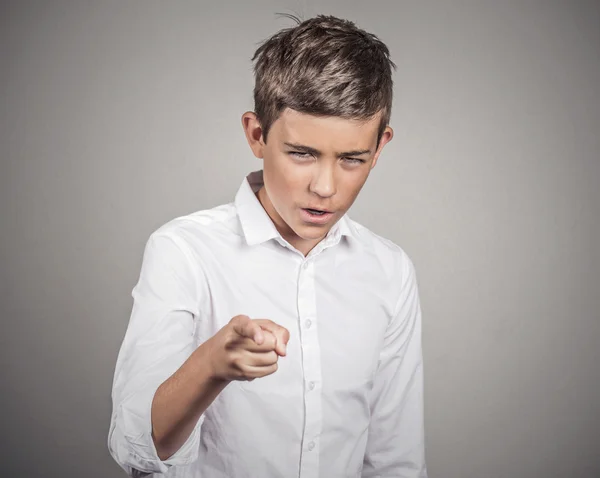 Angry teenager, pointing finger at someone, displeased — Stock Photo, Image