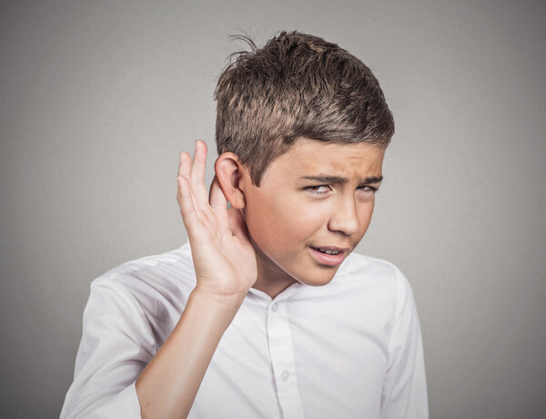 Hard of hearing man placing hand on ear asking to speak up