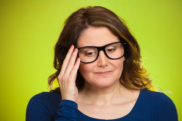 Mature, shy, sad woman playing nervously with glasses — Stock Photo, Image