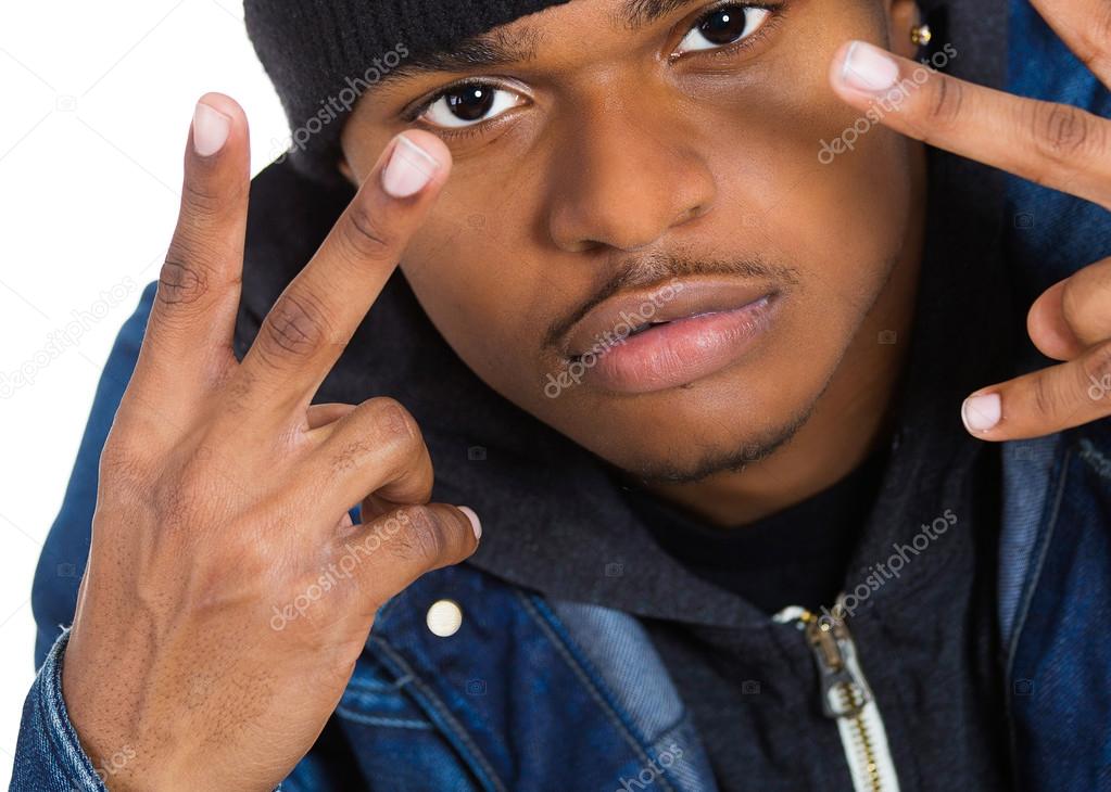 Headshot trendy young man, student holding up peace, victory sign 